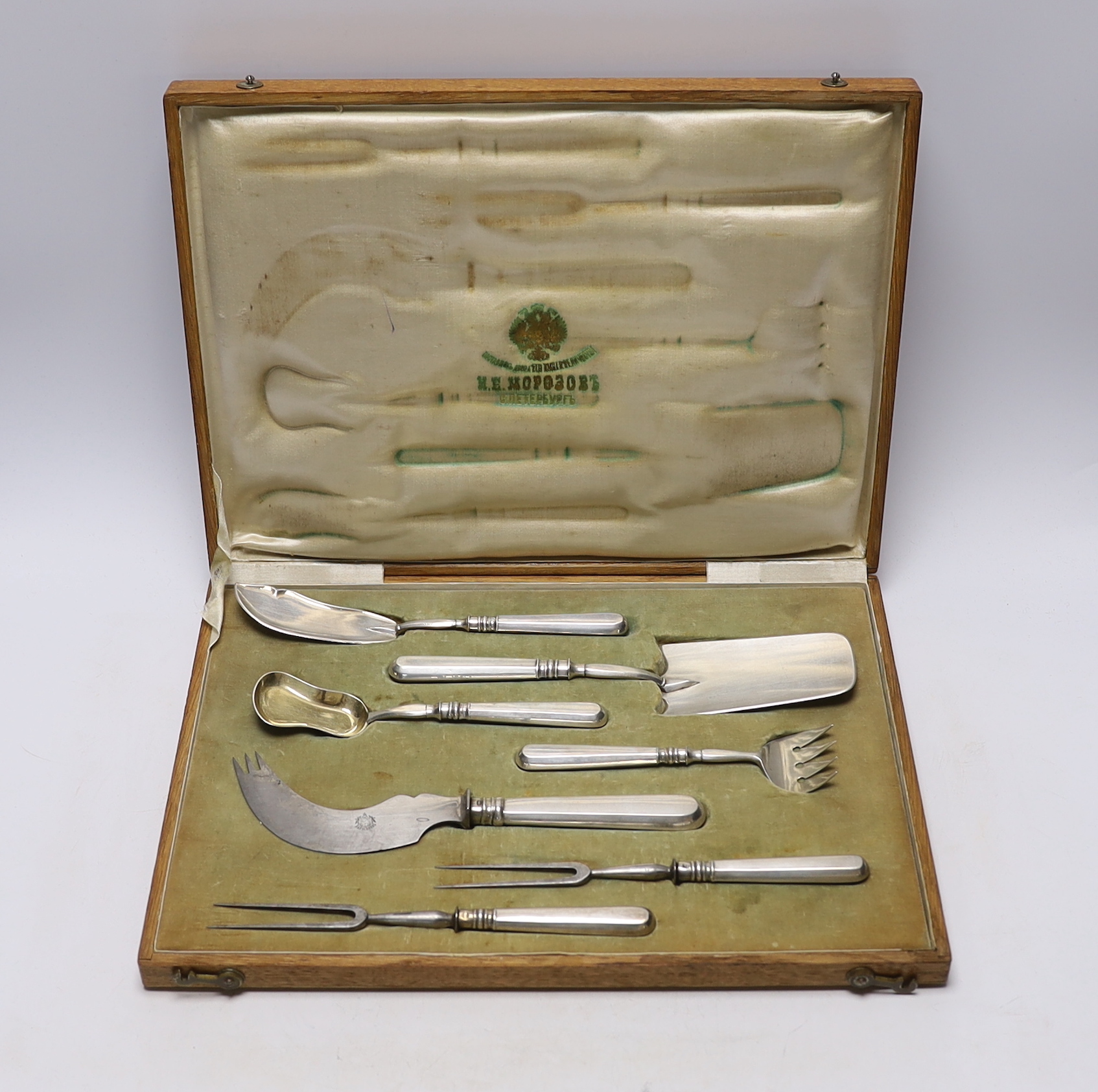 An early 20th century Russian 84 zolotnik seven piece serving set, by Ivan Morozov, largest piece 23.7cm, in original fitted oak case.